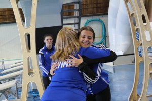 Carmen Landry receives her placement and a hug from Head Coach, Amanda Layton-Malone.