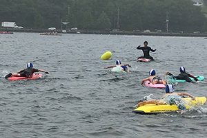 kids paddling in water for lifesaving competition