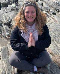 Female yoga instructor, outdoor photo on a rock