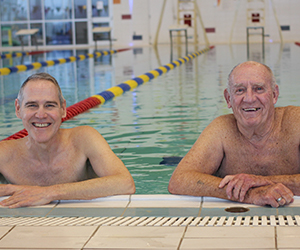 2 males in swimming pool for February member profile