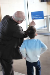 Russell with grandson Luke, reading the new room sign together